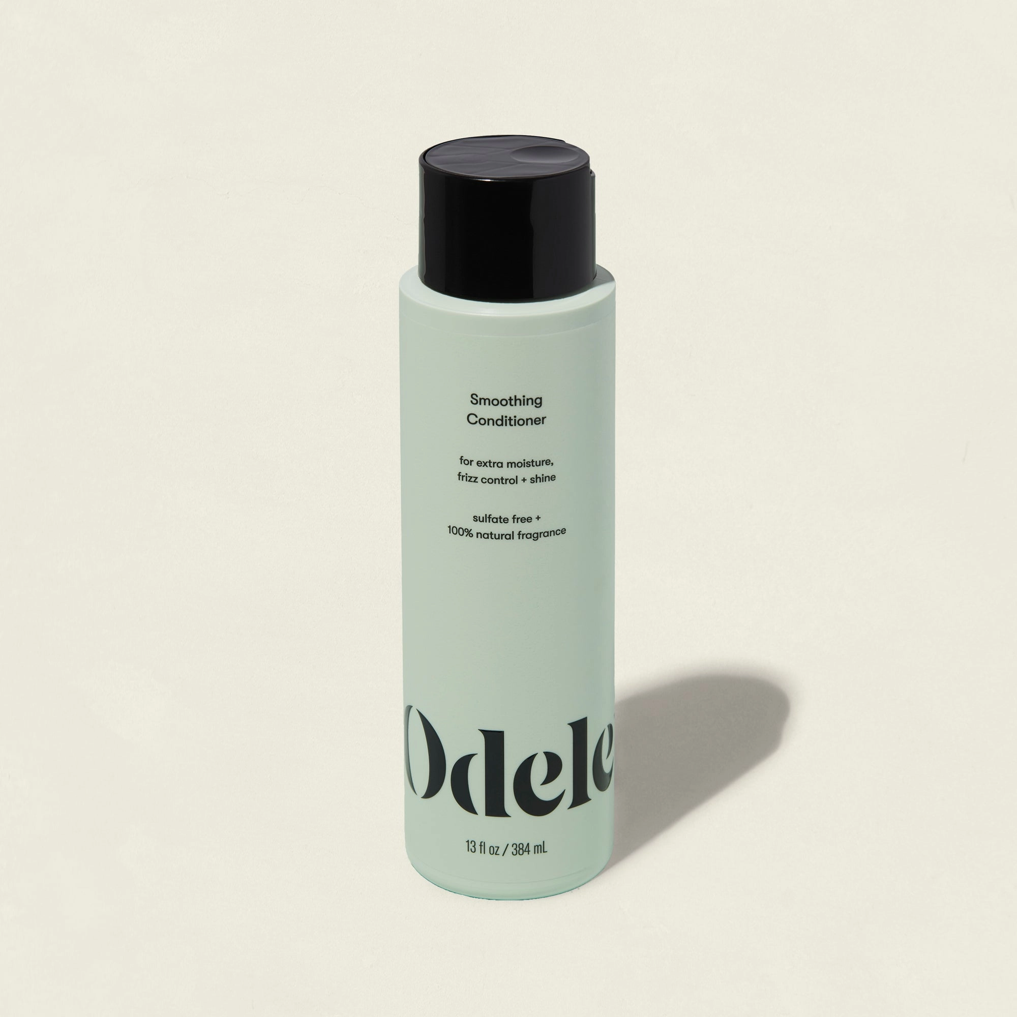 A light green bottle of Smoothing Conditioner with a black cap, shown on a plain background